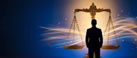 Silhouette of a businessman standing before glowing golden scales of justice on a blue background, symbolizing law, balance, and legal authority.
