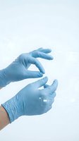 Medical professional hands in blue latex gloves holding protective gesture on white background for healthcare safety and hygiene concepts.