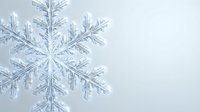 Delicate ice crystal snowflake with intricate geometric patterns and fine details on soft gray background for winter holiday designs.
