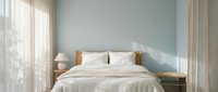 Modern minimalist bedroom interior with wooden bed frame, white bedding, soft natural lighting through sheer curtains, creating serene sleeping space.