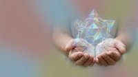 Hands holding glowing geometric star with sacred geometry patterns on soft rainbow gradient background for spiritual healing and meditation concepts.