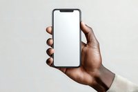 African American hand holding modern smartphone with blank white screen against neutral background, perfect for app or website mockup.