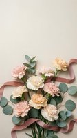 Elegant carnation bouquet with eucalyptus leaves and dusty rose ribbon on neutral background for wedding invitations and romantic greeting cards.
