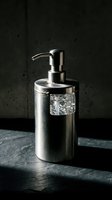 Luxury stainless steel soap dispenser with crystal accent on dark stone surface for modern bathroom and kitchen interior design.