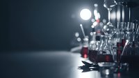 Professional film production equipment with bright studio lights and camera gear creating dramatic lighting effects on dark background.