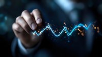 Glowing blue financial chart line with sparkles and bokeh effects shown by business person hand in dark background, representing market analysis and trading.
