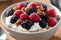 Healthy breakfast bowl with fresh raspberries, blackberries, walnuts and creamy yogurt. Nutritious morning meal for wellness and diet concepts.