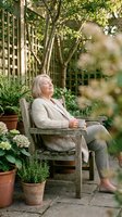 Senior Caucasian woman relaxing on wooden garden bench with coffee cup surrounded by potted plants and greenery in peaceful outdoor patio setting.