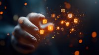 Hand touching digital interface with glowing orange app icons floating in dark space, creating magical technology interaction effect with bokeh lights.