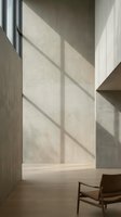 Minimalist interior with dramatic window shadows on concrete wall, wooden furniture and warm natural light creating geometric patterns in modern space.