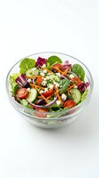 Fresh vegetable salad with mixed greens, tomatoes, cucumbers, carrots and feta cheese in glass bowl on white background, ready for healthy eating and nutrition content.