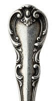 Ornate silver spoon handle featuring elaborate baroque scrollwork and acanthus leaf details, showcasing vintage metalwork craftsmanship and decorative design elements.