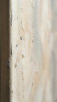 Weathered white painted wall surface with peeling paint and cracks showing age and deterioration for renovation or restoration projects.