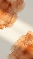 Abstract watercolor background with warm orange and brown tones flowing into soft beige gradients for artistic design projects.