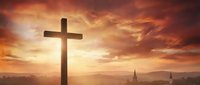 Wooden cross silhouette against dramatic sunset sky with golden clouds over mountain landscape for spiritual and religious themes.