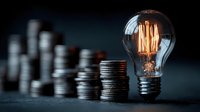 Glowing vintage light bulb with warm filament next to stacks of coins representing energy costs, electricity bills, and financial planning concepts.