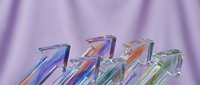 Colorful transparent glass arrows pointing upward on purple background representing growth, success, progress and business development concepts.