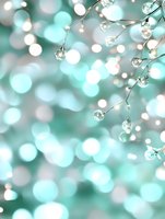 Delicate crystal droplets on branches against soft mint green bokeh background create dreamy winter atmosphere for holiday designs and seasonal greetings.