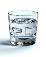 Clear glass filled with water and ice cubes on white background, showing liquid refreshment with transparent reflections and refractions in crystal tumbler.