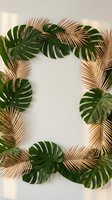 Tropical frame with golden palm leaves and green monstera creating elegant border on neutral background for luxury design projects.