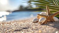 Starfish and palm leaf on sandy tropical beach with sparkling ocean bokeh background and smooth pebbles creating serene summer vacation atmosphere.