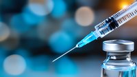 Medical syringe with needle and vaccine vial on blurred blue background with bokeh lights, healthcare and immunization concept.