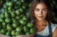 Young Caucasian woman with freckles and blue eyes holding burlap sack of fresh green figs at organic farm. Natural harvest concept for healthy eating.