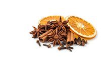 Aromatic winter spices with dried orange slices, star anise, cinnamon sticks and cloves isolated on white background for seasonal cooking and mulled wine recipes.