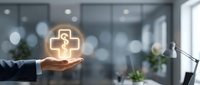 Healthcare professional holding glowing medical cross symbol in modern office environment, representing digital health services, telemedicine, and medical care innovation.