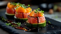 Gourmet avocado and salmon appetizers with microgreens on slate board for fine dining restaurant menu presentation and culinary photography.
