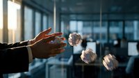 Hands of male professional reaching toward floating light bulbs in modern office environment, symbolizing innovation and business ideas.