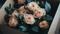 Delicate peach garden roses with emerald green leaves in moody lighting create romantic atmosphere. Soft petals and dark shadows add dramatic effect.