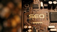SEO text engraved on computer circuit board with electronic components and golden pathways for digital marketing and search engine optimization.