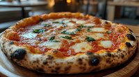 Traditional Neapolitan style pizza with melted mozzarella, tomato sauce and fresh basil leaves on charred artisanal crust, served on wooden board in restaurant setting.