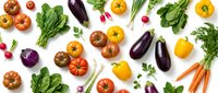 Fresh organic vegetables flat lay with colorful tomatoes, eggplants, bell peppers, leafy greens, carrots and radishes on white background for healthy cooking.