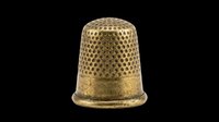 Brass thimble with textured dimpled surface and flat base, isolated on transparent background. Ready for clipart, print-on-demand, sublimation, and design projects.