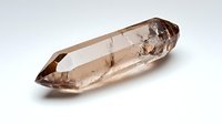 Smoky quartz crystal point with natural inclusions and terminations isolated on white background for healing meditation and spiritual practices.