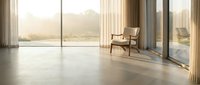 Modern minimalist living room interior with wooden chair and large windows overlooking city skyline at sunset creating warm natural lighting atmosphere.