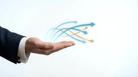 Businessman hand presenting flowing arrows symbolizing growth, direction and business strategy concepts for corporate presentations and marketing materials.