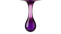 Liquid purple dripping from glass surface against white background, isolated design element for beverages, cosmetics, and product packaging concepts.