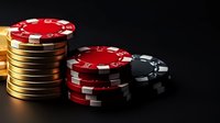 Stacks of poker chips in red, gold and black on dark background with dramatic lighting, creating atmosphere of high-stakes gambling and casino entertainment.