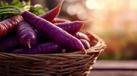 Fresh purple carrots in rustic wicker basket against blurred background, organic farm vegetables with green tops, healthy natural produce for cooking.