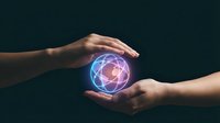 Two hands holding glowing digital globe with blue and pink light, representing global connection, technology transfer, and worldwide network communication.