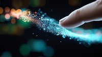 Human hand touching magical glowing particles with sparkling light effects and bokeh background for digital technology concepts.