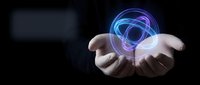 Businessman hands holding glowing blue and purple holographic sphere with digital rings on dark background for technology and innovation concepts.
