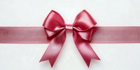 Pink satin ribbon bow on white background, isolated gift decoration element for holidays, celebrations, presents and festive occasions.