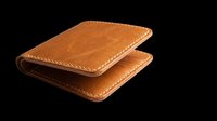 Tan leather bifold wallet with stitched edges, isolated on transparent background. Ready for t-shirt design, clipart, print-on-demand, sublimation, and sticker applications.