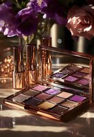 Luxury rose gold makeup palette with purple eyeshadows and lipsticks on marble surface with fresh flowers for beauty and cosmetics advertising.