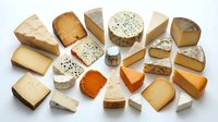 Assorted cheese varieties including cheddar, brie, and blue cheese wedges arranged on white background for food photography, culinary design, restaurant menus, and dairy product marketing.