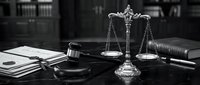 Legal justice concept with scales of justice, gavel and law books on dark wooden desk in attorney office for courtroom proceedings and litigation.